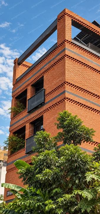 Same tower from the corner; sawtooth brick banding across the elevation