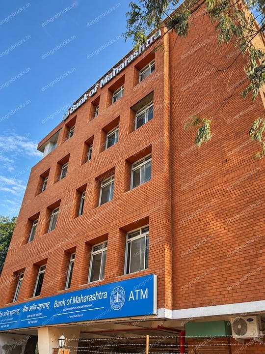 Completed Bank of Maharashtra branch, punched windows in exposed brick